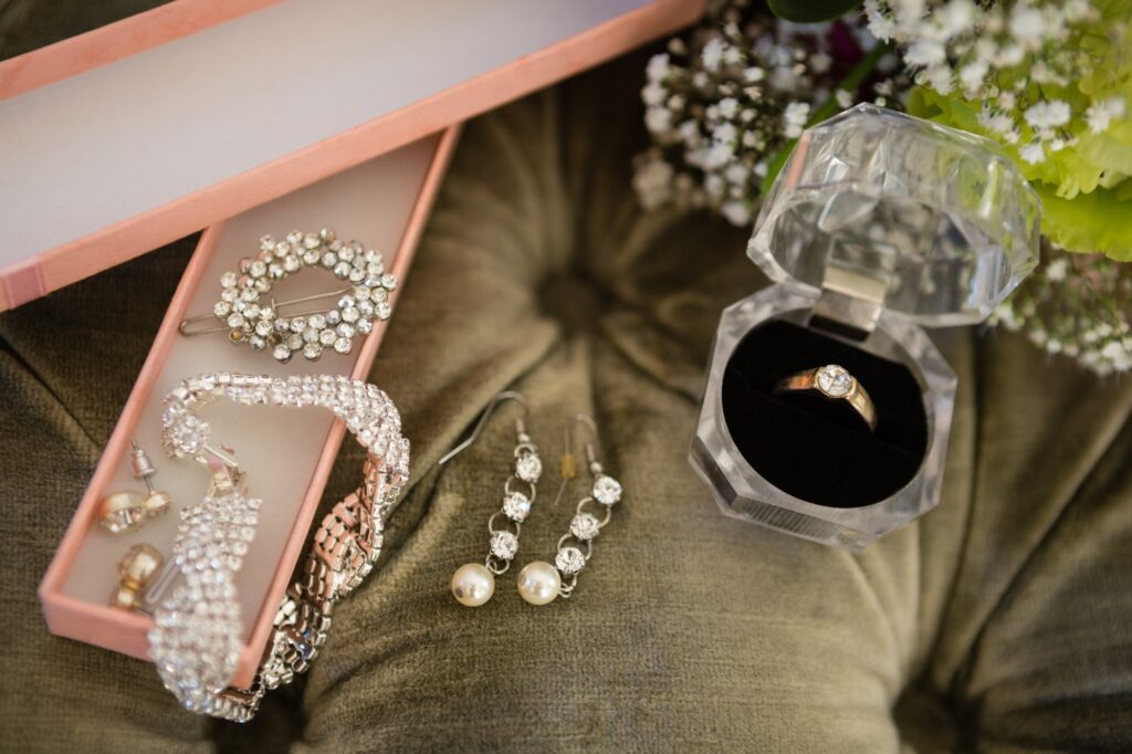 High angle view of bride jewelry on sofa